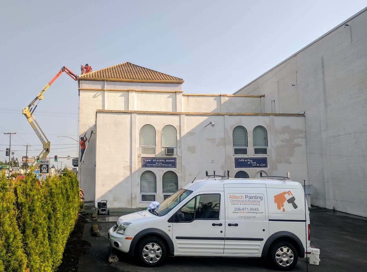 Alltech Painting crew pressure washing a West Seattle exterior before painting